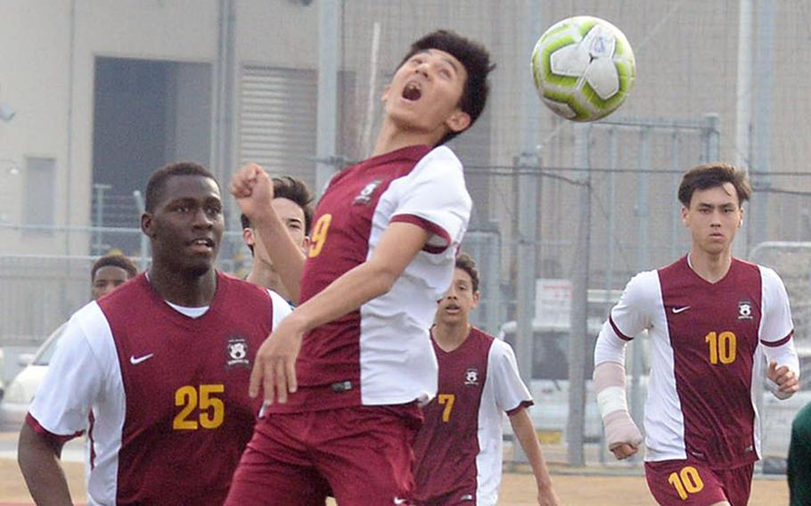 Matthew C. Perry's Yugo Cooley heads the ball between Robert D. Edgren defenders during Friday's Perry Cup boys soccer match at Marine Corps Air Station Iwakuni, Japan. The Samurai won 5-0. Perry went on to qualify for Saturday's fifth-place match; the Eagles play Saturday for ninth place.