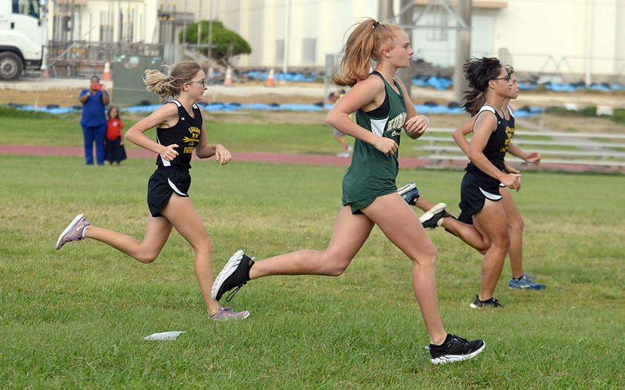 Kadena freshman Sierra Taysom at far right leads the girls pack off the start line during Friday's season-opening Okinawa cross country meet.