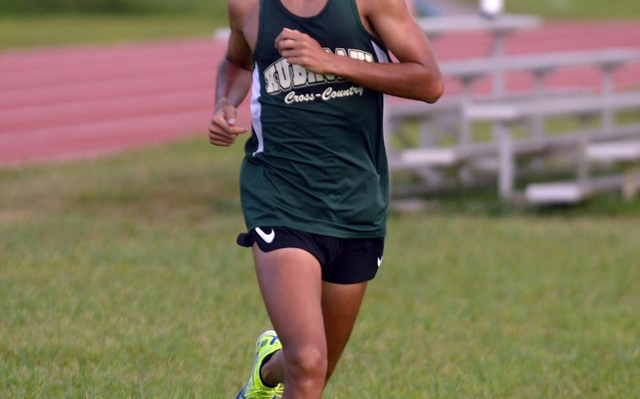 Kubasaki senior Arthur Parra crosses the finish line first among boys in 16 minutes, 59 seconds.