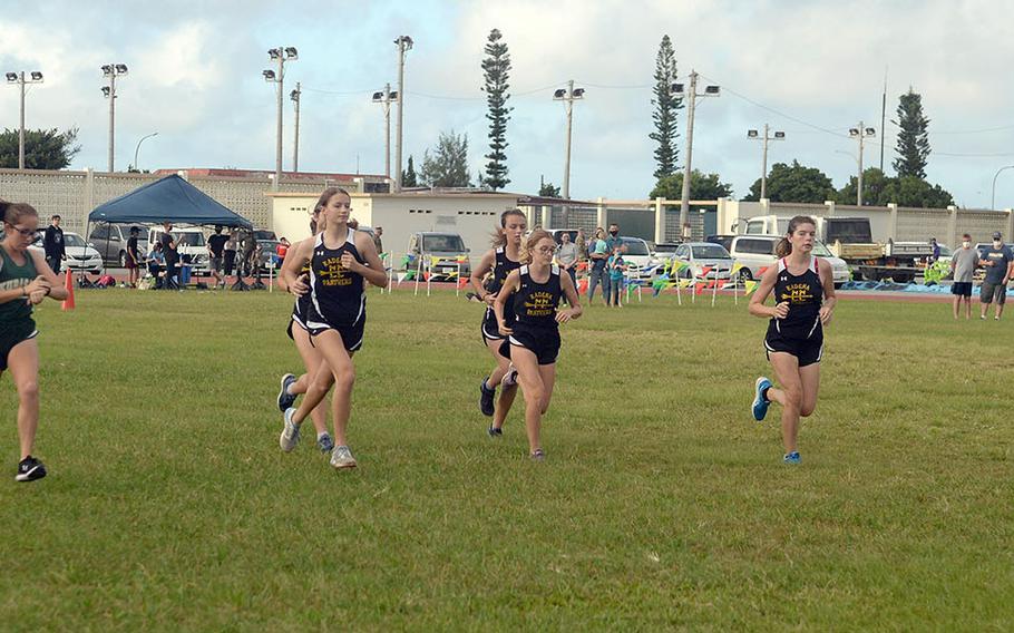 Kubasaki's Jessica Nation, far left, and Kadena's Isamar Vargas, far right, flank the field of runners at the start of Friday's Okinawa girls cross country race. Vargas finished third in 23 minutes, 12.33 seconds and Nation fifth in 23:34.30.