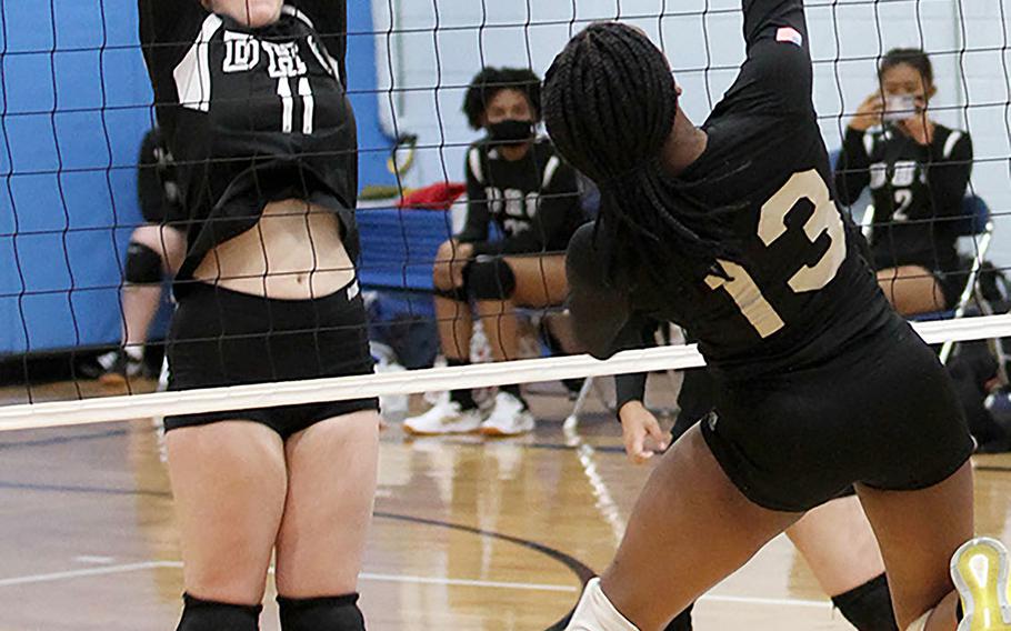 Osan Black's Tailan Hickey goes up to hit against Daegu's Lexie Berry during Friday's DODEA-Korea girls volleyball. Osan Black beat the Warriors 22-25, 25-23, 25-21.