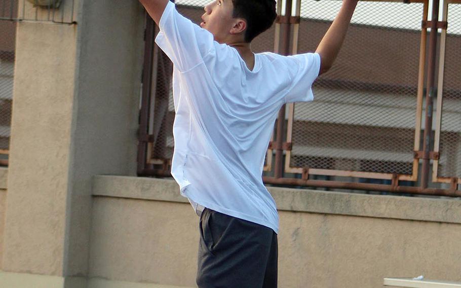 Humphreys' Kyung Joon Flannery serves against Osan's Joshua Kim during Friday's Korea tennis meet. Flanner won 8-1.