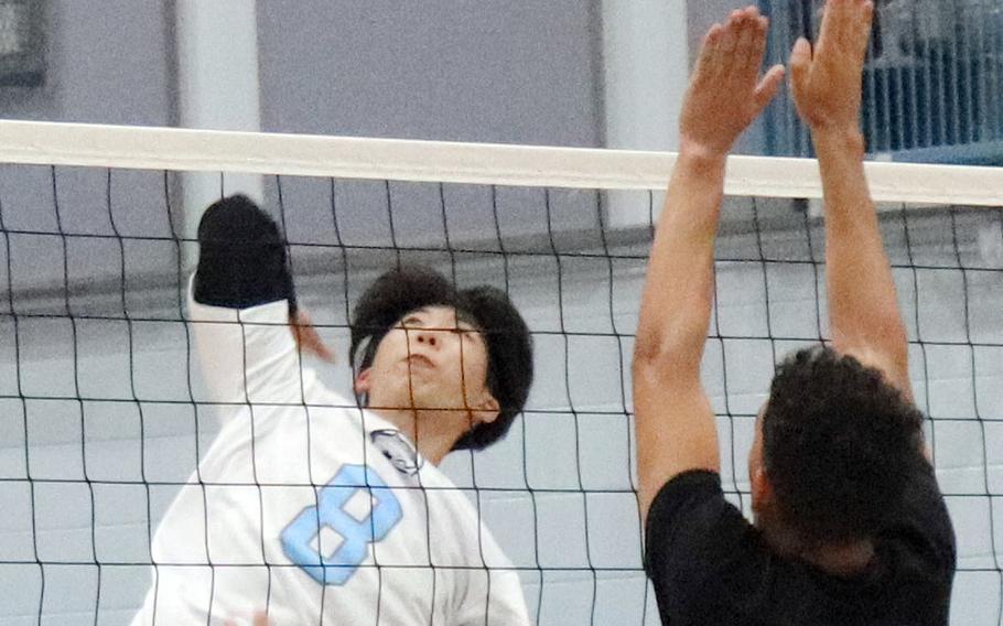 Osan's Tim Petrae tries to hit past Daegu's Jordan Brown during Friday's Korea boys volleyball match. The Cougars beat the Warriors 26-24, 25-16.
