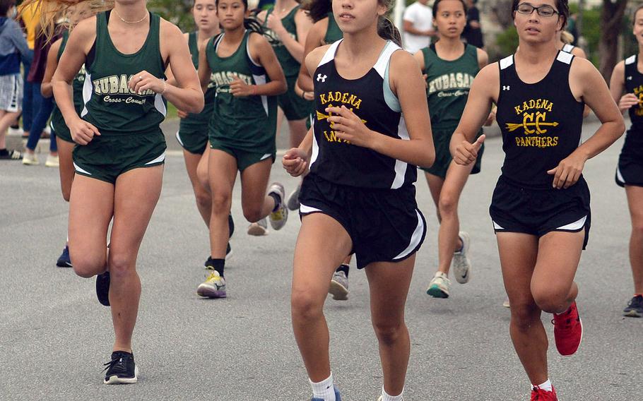 Kubasaki's Jessica Nation and Kadena's Karise Johnson and Isamar Vargas lead the pack off the start line of Friday's Okinawa cross country meet. Johnson won her third race of the season in 20 minutes, 7.67 seconds; Vargas took third in 21:54.84 and Nation fourth in 21:59.67.