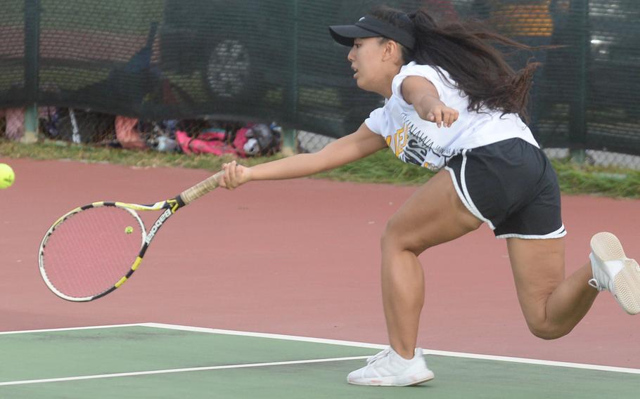 Kadena senior Noelle Asato lunges for a forehand groundstroke against teammate Mayann Rivera during a knockout-bracket match Wednesday in the Okinawa district singles tennis tournament. Asato won 6-4, but lost in the final to Kubasaki's Willow Lewis 8-2.