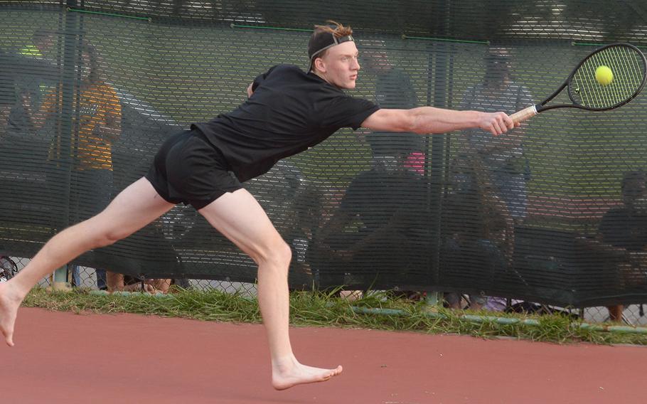 Kadena senior Brett Davis lunges for a backhand -- in bare feet -- against teammate R.J. Smola in a knockout-bracket match Wednesday in the Okinawa district tennis singles tournament. Smola beat Davis in a tiebreak 7-6 (8-6).