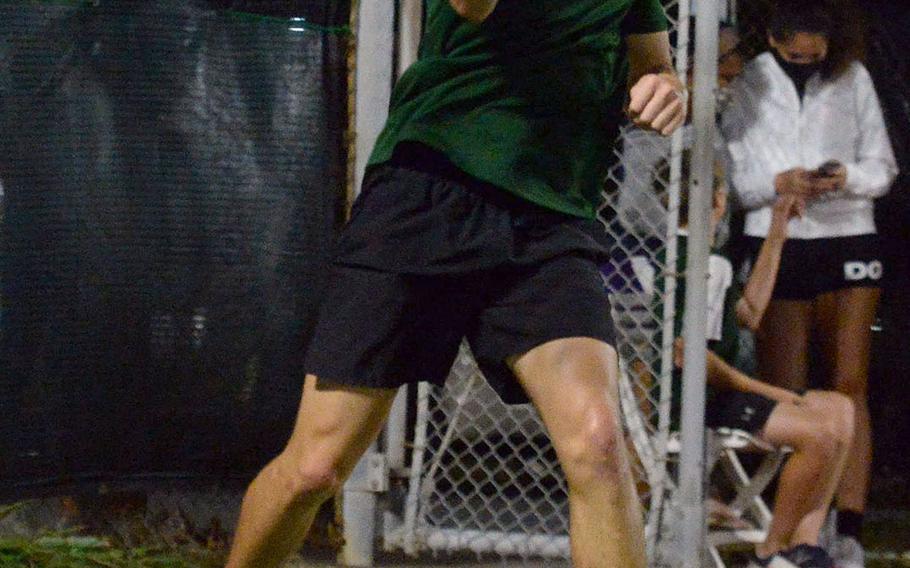 Kubasaki senior Henry Ruksc sends a forehand return to teammate Kai Grubbs, the eventual Okinawa district boys singles tennis champion.