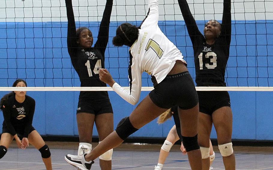 Humphreys Gold's Capriel Joseph spikes against Osan Black's Tatiana Lunn and Tailan Hickey during Wednesday's DODEA-Korea volleyball match. Gold won 25-20, 23-25, 25-20.