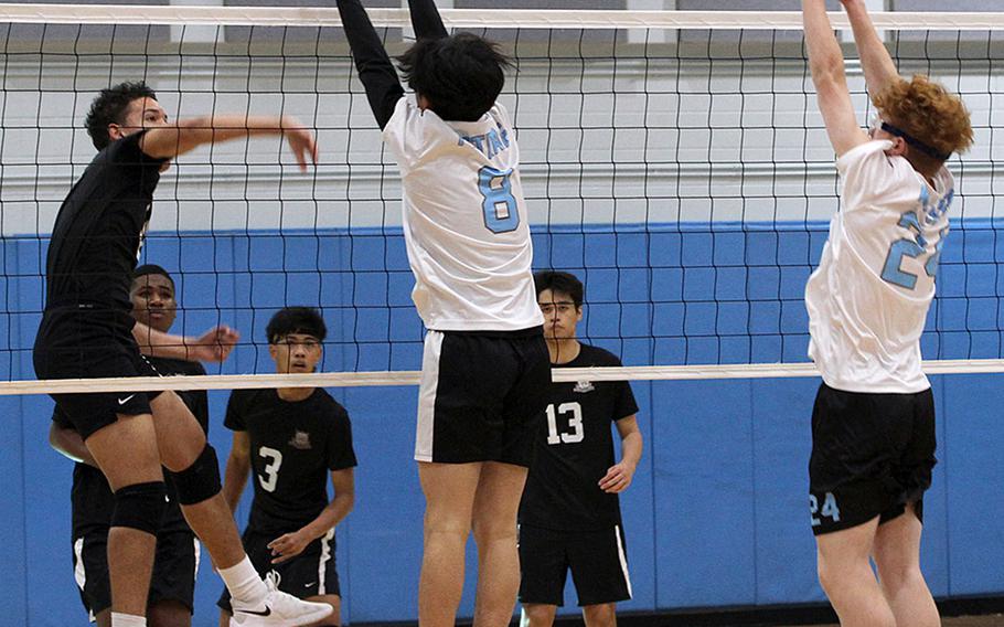 Daegu's Jordan Brown spikes against Osan's Timothy Petrae and Martin Walker during Saturday's DODEA-Korea boys volleyball match. The Cougars won 25-14, 25-21.
