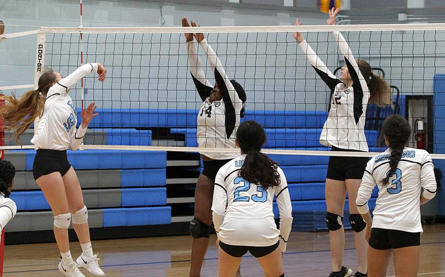 Osan's Naomi Elliot spikes over Humphreys' Janae Bennet and Bridgette Elkins during Wednesday's DODEA-Korea volleyball match. Osan's Black team swept Humphreys' Gold and Black teams in two three-set matches. Humphreys' teams repaid the favor, beating Osan Blue in a pair of two-set matches.