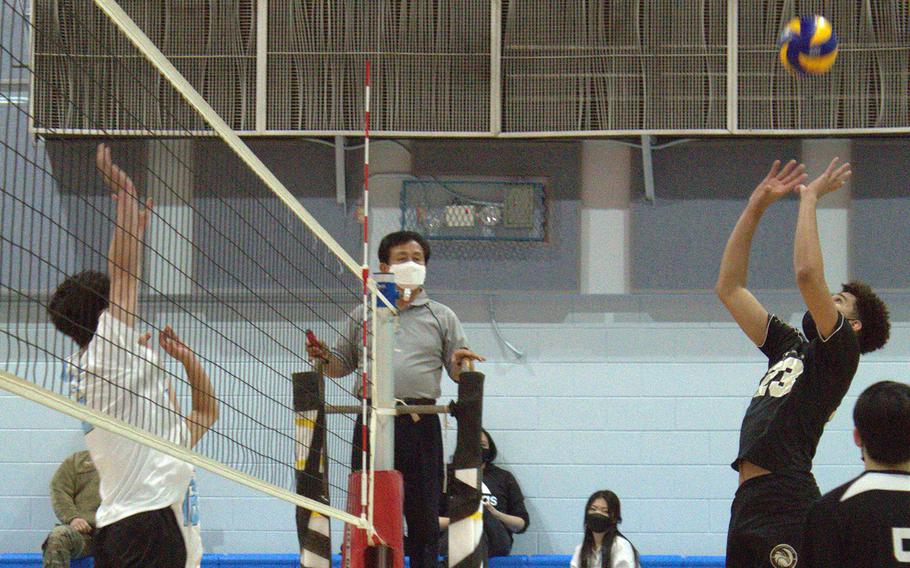 Humphreys' Collin Metcalf sets against Osan during Wednesday's DODEA-Korea volleyball. The Cougars swept two matches, beating Humphreys Gold 25-20, 27-25 and Humphreys Black 25-21, 28-26.