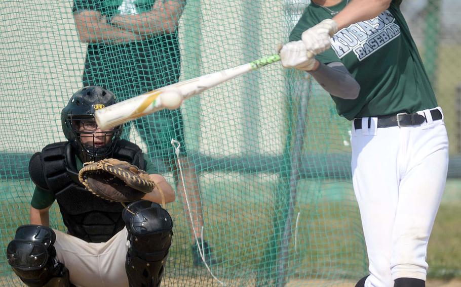 Kubasaki sophomore Jeffrey Owens takes his cuts during a Wednesday practice, under the watchful eye of longtime Dragons coach Randy Toor with senior Nick Patton behind the plate.