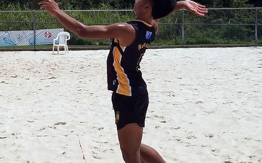 Guam High's Treydan Rosario sends a jump serve against St. John's during Saturday's Guam boys beach volleyball match. The Knights won all three matches.