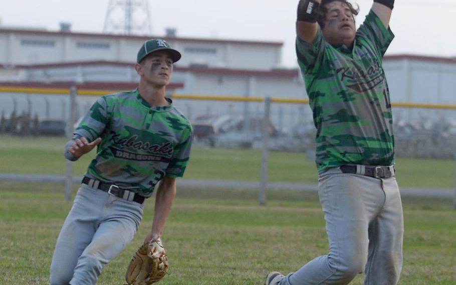 Kubasaki third baseman Kai Grubbs catches a popup as shortstop Jeffrey Owens backs him up during Thursday's Okinawa baseball game. The Dragons won 16-15.