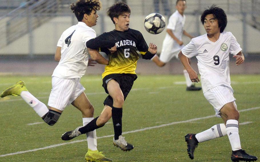 Kadena's Tyler Smith drives the ball between Kubasaki's Isaiah Carrillo and Kia Fowler during Wednesday's Okinawa season-opening boys soccer match. The Panthers won 1-0.