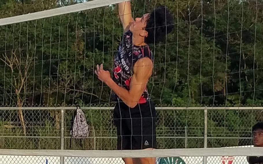 Jared Aguon goes up to spike for Guam High against Father Duenas Memorial Gold during Thursday's beach volleyball match. The Panthers' A and B teams won their matches, while the Friars C team won its match.