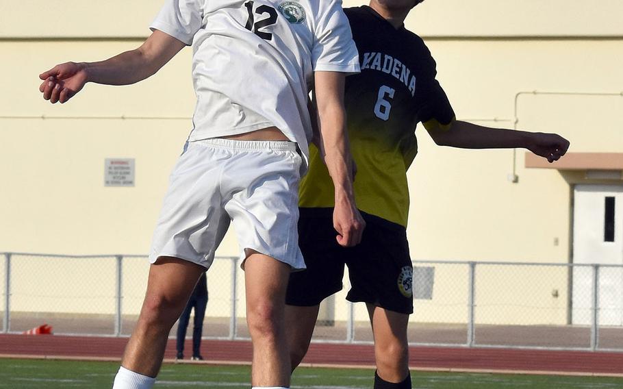 Kubasaki's Henry Ruksc and Kadena's Tyler Smith go up to head the ball during Friday's Okinawa boys soccer match. The Dragons won 3-0.