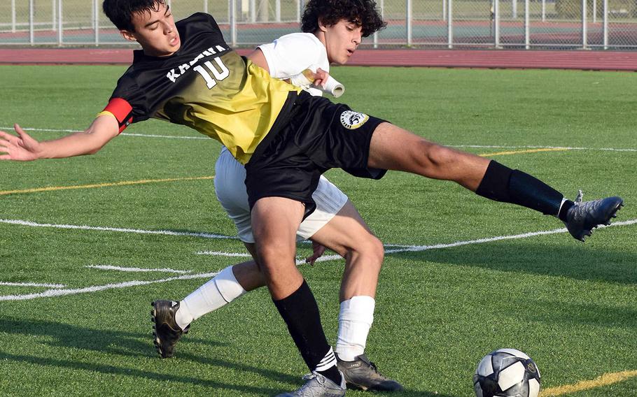 Kadena's Gideon Summers and Kubasaki's Thiago Facchini scrum for the ball during Friday's Okinawa boys soccer match. The Dragons won 3-0.