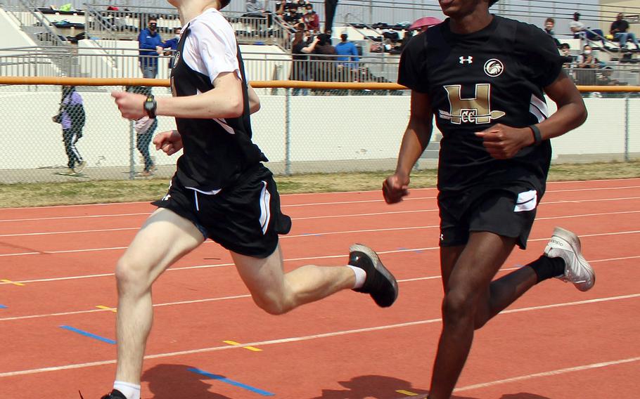 Humphreys' Joshua Newson and Jax Watson cross the finish line second and third in the boys 1,600 during Saturday's DODEA-Korea track and field meet. Osan's Parker Hendrickson won the race in 5 minute, 5.78 seconds; Watson was second in 5:19.48 and Newson third in 5:19.70.