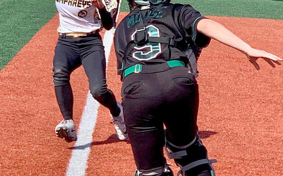 Humphreys' Nichole Christian gets into a rundown and is chased by Daegu catcher Maddie Mihalic during Saturday's DODEA-Korea softball game. The Warriors won 8-6 and captured the regular-season title.