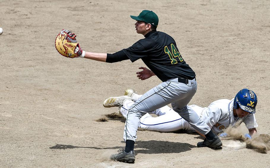 Robert D. Edgren first baseman Dennis Nelson awaits the pickoff throw as Yokota's Connor Rowan dives back to the bag during Saturday's DODEA-Japan baseball game. The Eagles won 6-5, then Yokota beat Edgren 11-1 to split the series.