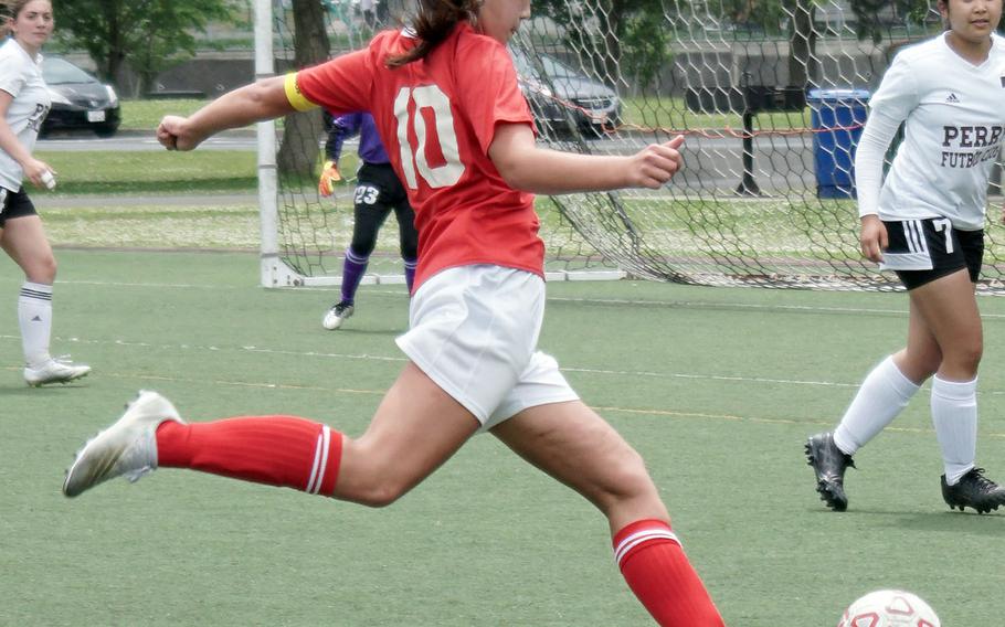 E.J. King's Mali Schinker boots the ball against Matthew C. Perry during Saturday's DODEA-Japan girls soccer matches. The Cobras won both matches 6-0 and 3-0, capping an 8-0 sweep of their matches with the Samurai.