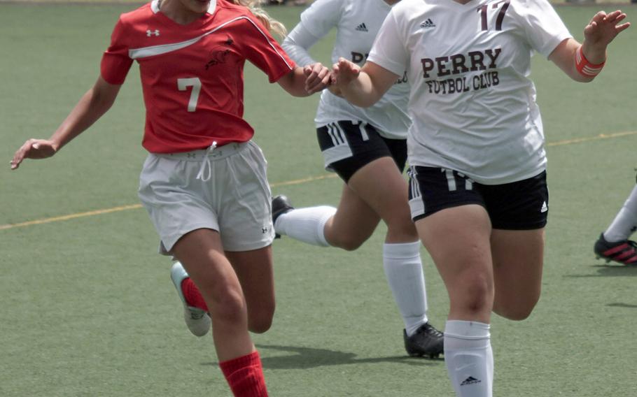 E.J. King's Shayden Galinato-Moriwaki and Matthew C. Perry's Mackenzie Game chase the ball during Saturday's DODEA-Japan girls soccer matches. The Cobras won 6-0 and 3-0, capping an 8-0 sweep of their season series with the Samurai.