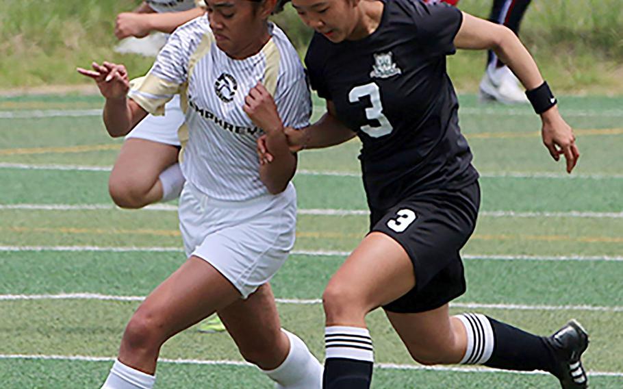 Humphreys' Makayla Shaw and Daegu's Leah Williamson chase the ball during Saturday's DODEA-Korea girls soccer championship match. The Blackhawks won 2-0.