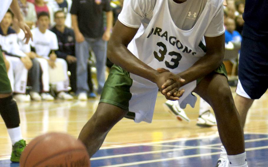 Kubasaki center Kentrell Key grimaces in frustration as he loses the ball out of bounds against Hong Kong International during Saturday's boys championship game.