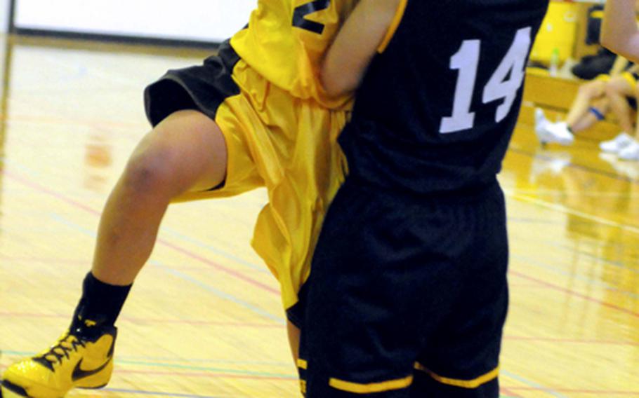 Kadena's Maria Vaughan drives on Anne Roffler of Taipei American during Saturday's girls fifth-place game.