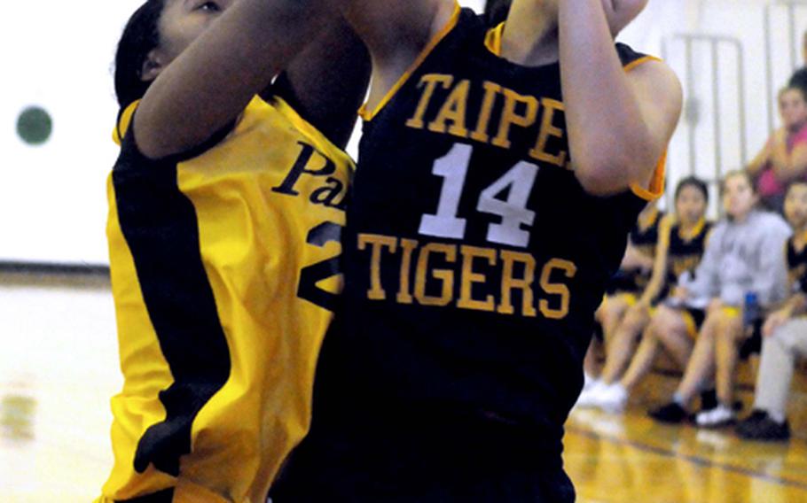 Anne Roffler of Taipei American beats Mariah Harris of Kadena for a rebound during Saturday's girls fifth-place game in the 41st Hong Kong International School Holiday Basketball Tournament. Harris scored the game-winning basket with 13 seconds left as Kadena edged Taipei 60-59.