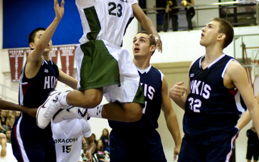 Kubasaki guard Kai Yamaguchi puts up a shot through three Hong Kong International defenders during Saturday's boys championship game.