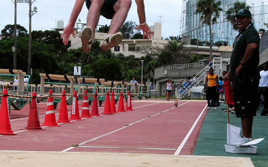 Jack MacMannis from Kubasaki High School flies through the air in the Boys Long Jump at the Okinawa Activities Council Track Meet held at Koza Stadium Friday afternoon. Thomas McDonald from Kadena High School won the event with a distance of 6.34 meters.