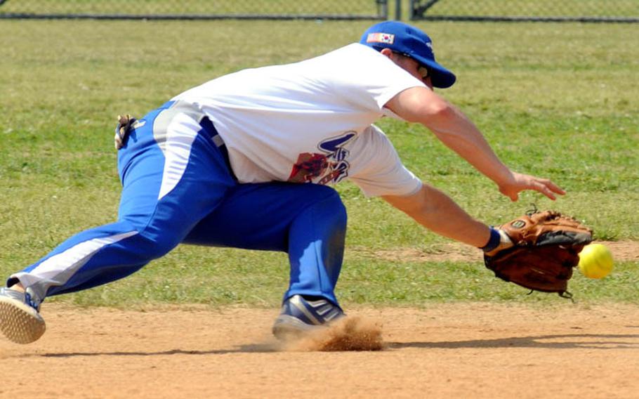 Kunsan Air Base shortstop Josh Willim can't find the handle on a Misawa Air Base ground ball during Sunday's champion bracket game in the men's A double-elimination playoff game in the 21st Pacificwide Open Interservice Softball Tournament at Field 2, FourPlex at Lombardo Field, South Post, Yongsan Garrison, South Korea. Misawa edged Kunsan 30-28.