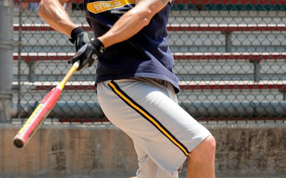 Mike Sharp of the International Guzzlers watches the flight of a fly ball against Daegu/Area IV during Sunday's knockout bracket game in the men's A double-elimination playoff game in the 21st Pacificwide Open Interservice Softball Tournament at Field 1, FourPlex at Lombardo Field, South Post, Yongsan Garrison, South Korea. Guzzlers rallied to eliminate Daegu 23-20. Sharp, 42, a retired Army sergeant first class from Garden Grove, Calif., played for the Guzzlers during his last tour in Korea, which lasted eight years. He flew 5,595 miles from his current home, Naples, Italy, to play in the tournament. He's married to the former Jen Davies, a 1992 Seoul American High School graduate.