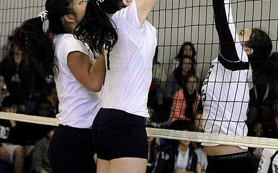 Karen Yates (7) of Morrison Academy Mustangs of Taiwan blocks a shot by Kaitlyn Nott of Daegu High Warriors during Friday's championship match in the Far East High School Girls Division II Volleyball Tournament at Kelly Fitness & Sports Center, Camp Walker, South Korea. Morrison defended its championship 25-6, 25-15, 25-11.