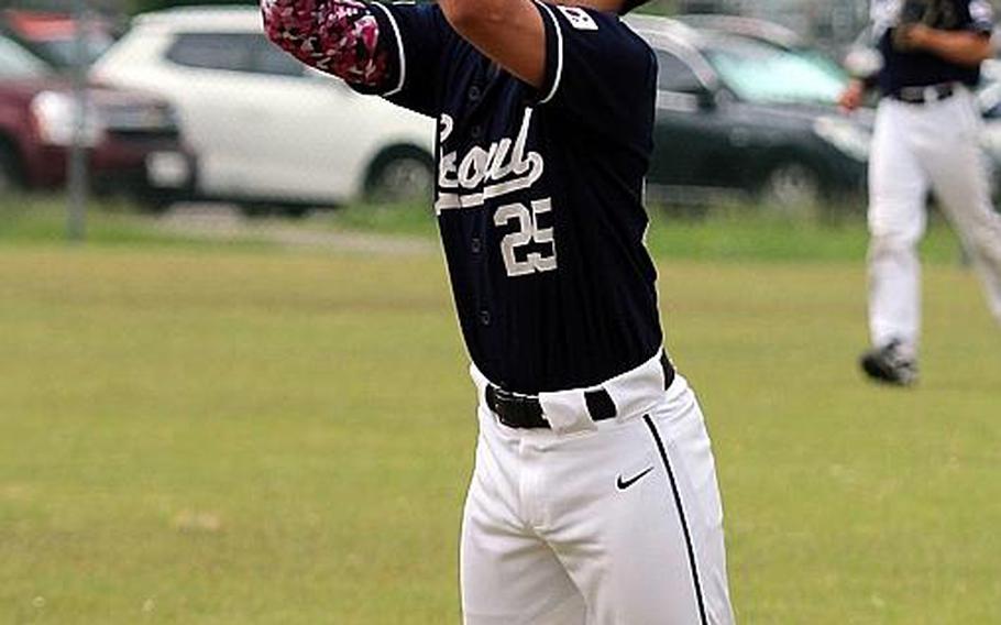 Seoul American's Eric Guzman snags a St. Mary's l popup during Monday's round-robin game in the Far East Division I Baseball Tournament. The Titans won 6-3.