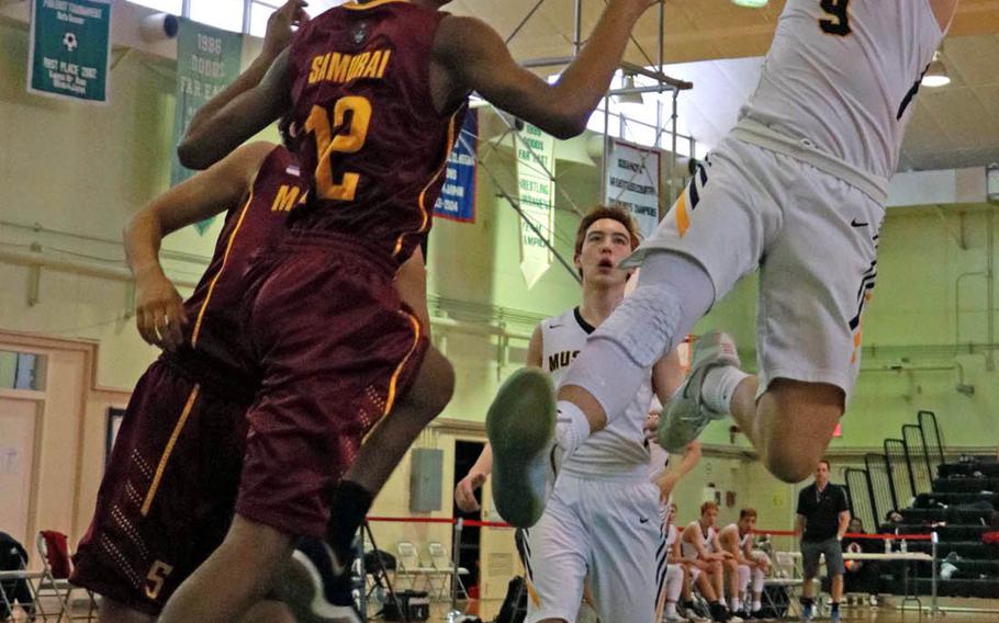 American School In Japan's Tyler Evert shoots a fadeaway against Matthew C. Perry defense during Wednesday's combined boys Far East tournament early-round game. The Mustangs won 74-28.