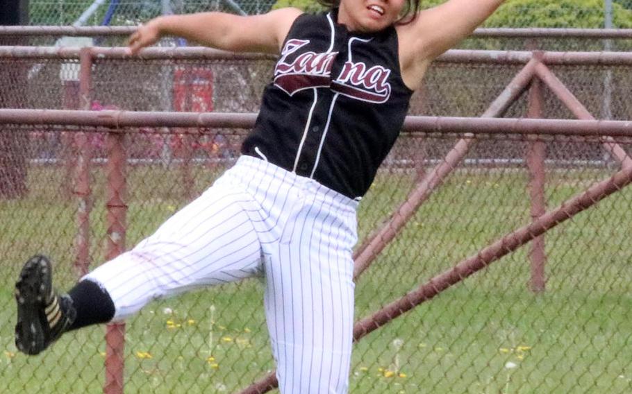 Zama American outfielder Haruki Fuentes lunges to catch a fly ball against Matthew C. Perry during Friday's pool-play game in the DODEA Japan softball tournament. The Trojans won 10-8.