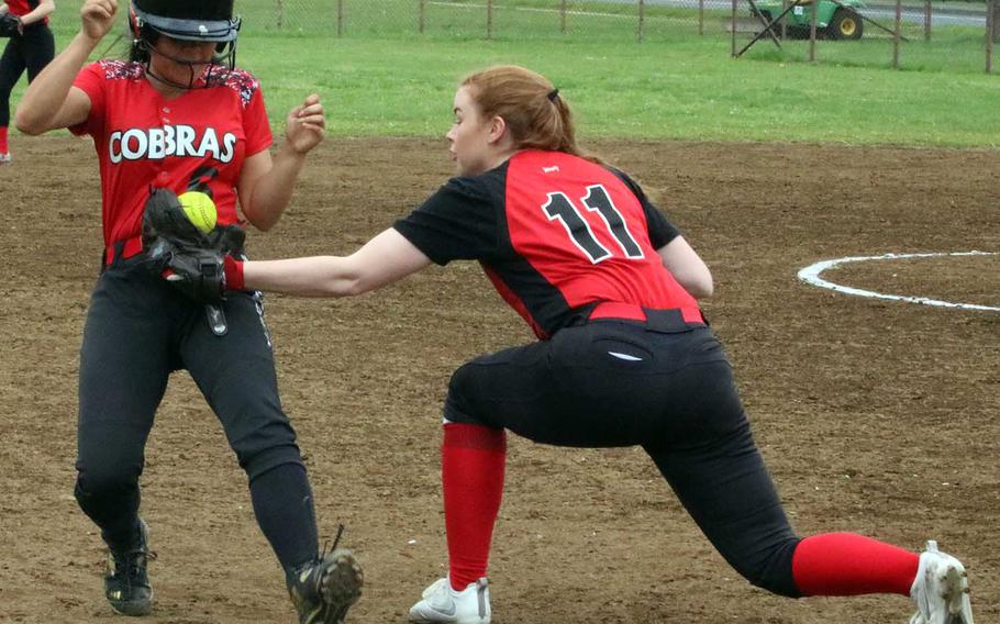 E.J. King's Haru Bellwood gets tagged out at third base by Nile C. Kinnick's Cassi Boyer during Friday's pool-play game in the DODEA Japan softball tournament. The Cobras won 9-8.