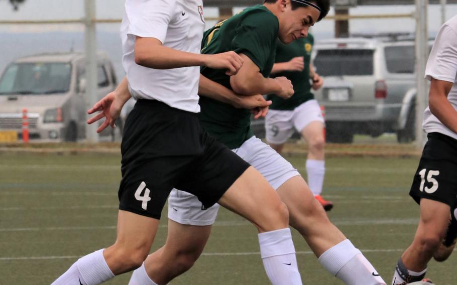 Zama American's Jefferson Lund and Robert D. Edgren's Joshua Hartley scuffle for the ball during Friday's single-elimination playoff match in the DODEA Japan boys soccer tournament. The Trojans won the match in penalty kicks.