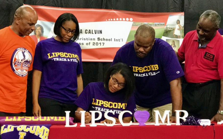 With parents and coaches looking on, Okinawa Christian senior sprinter-high jumper Tia Calvin signs a national letter of intent, committing to NCAA Division I Lipscomb University of Nashville, Tenn., in the Atlantic Sun Conference.