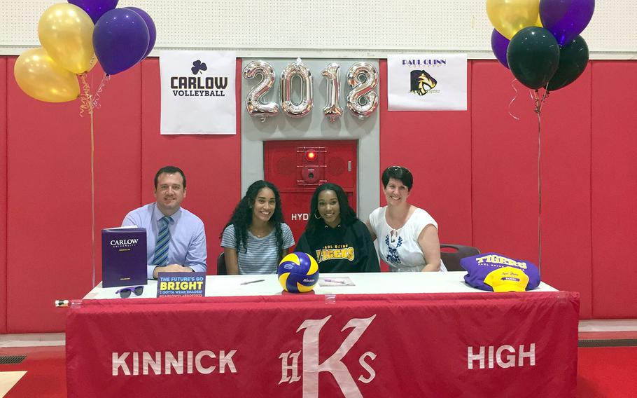 Nile C. Kinnick seniors Exotica Hall and Jade McGinnis have received partial scholarships to play volleyball in college, McGinnis at Paul Quinn College in Texas and Hall at Carlow University in Pennsylvania. At left is Kinnick assistant principal Craig Maxey; at right is Kinnick principal Dr. Jacqueline Ferguson.
