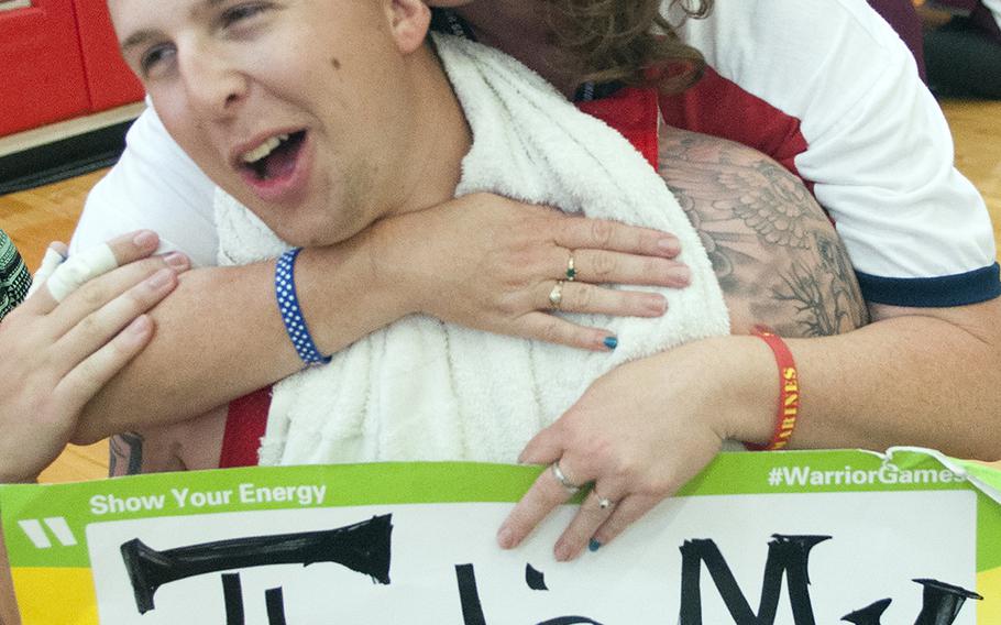 Theresa Mathis hugs her son, Lance Cpl. Duncan Mathis, on Tuesday, June 23, 2015, after the Warrior Games championship wheelchair basketball matchup between Team Marine Corps and Navy at Quantico Marine Base, Va.