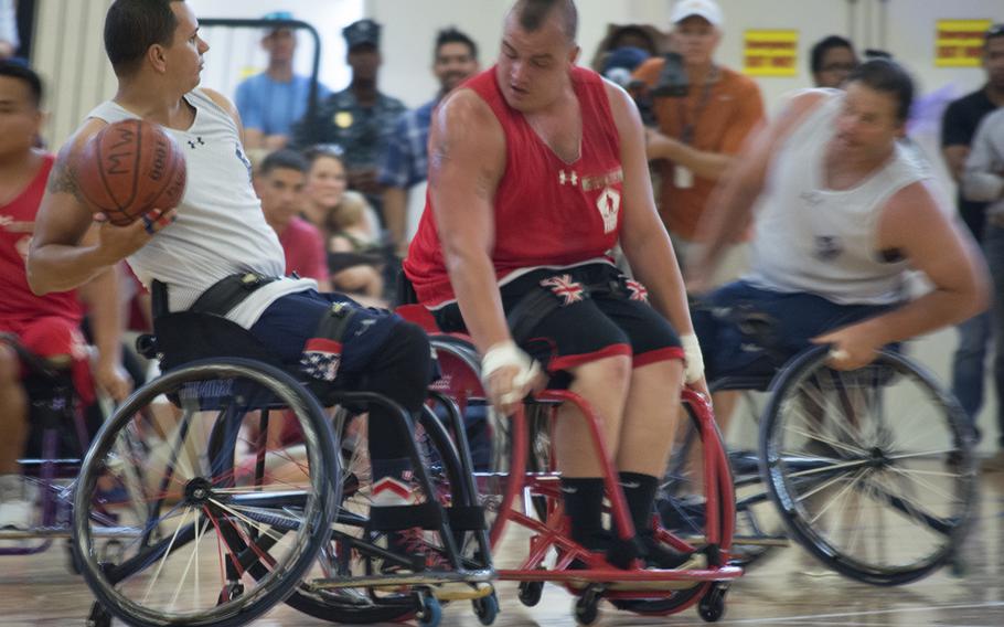Players chase after the guy with the basketball during the Navy vs. Marine match of the Warrior Games on June 23, 2015.