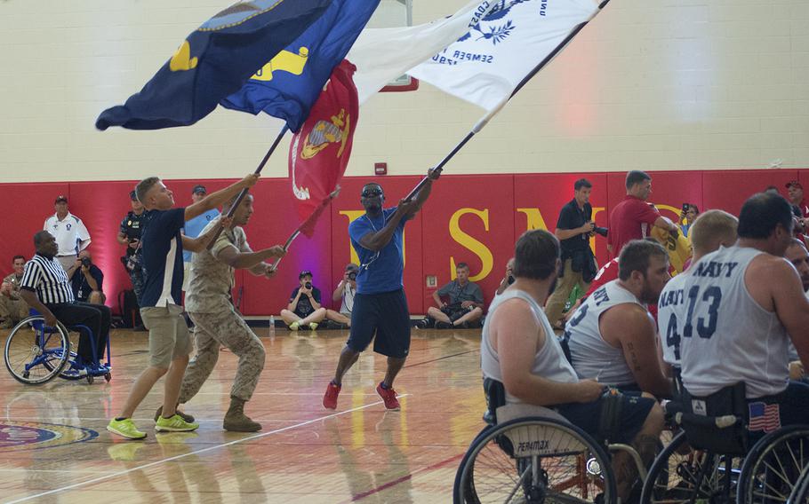 During a break, men waving flags stormed the court during the Navy vs Marines basketball game that was taking place during the Warrior Games on June 23, 2015.