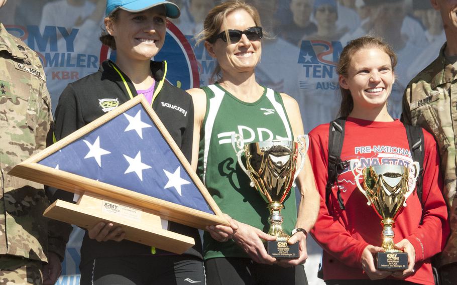 Tina Muir, Perry Shoemaker and Stephanie Bryan of Frederick, Md., finished pose with their awards for being the top female finishers at the Army Ten-Miler outside the Pentagon on Oct. 11, 2015.