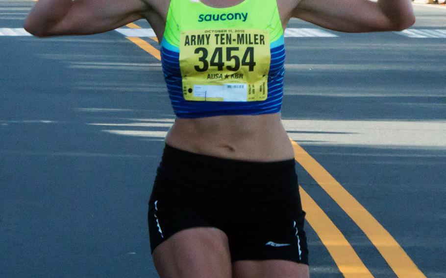 Tina Muir of Lexington, Ky., wins the women's title at the 2015 Army 10 Miler, October 11, 2015.