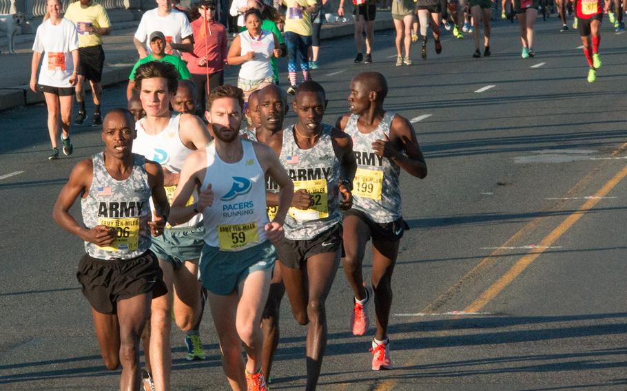 The lead pack in the 31st Army Ten-Miler crosses the bridge from Arlington, Va. to Washington, D.C., October 11, 2015.