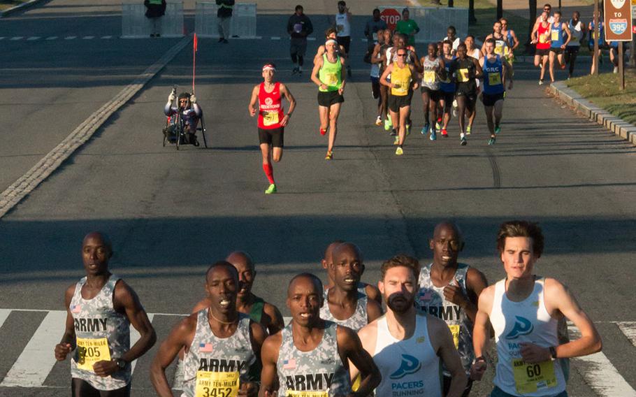 With Arlington National Cemetery in the background, runners cross the bridge into Washington, D.C, during the 31st Army Ten-Miler, October 11, 2015.